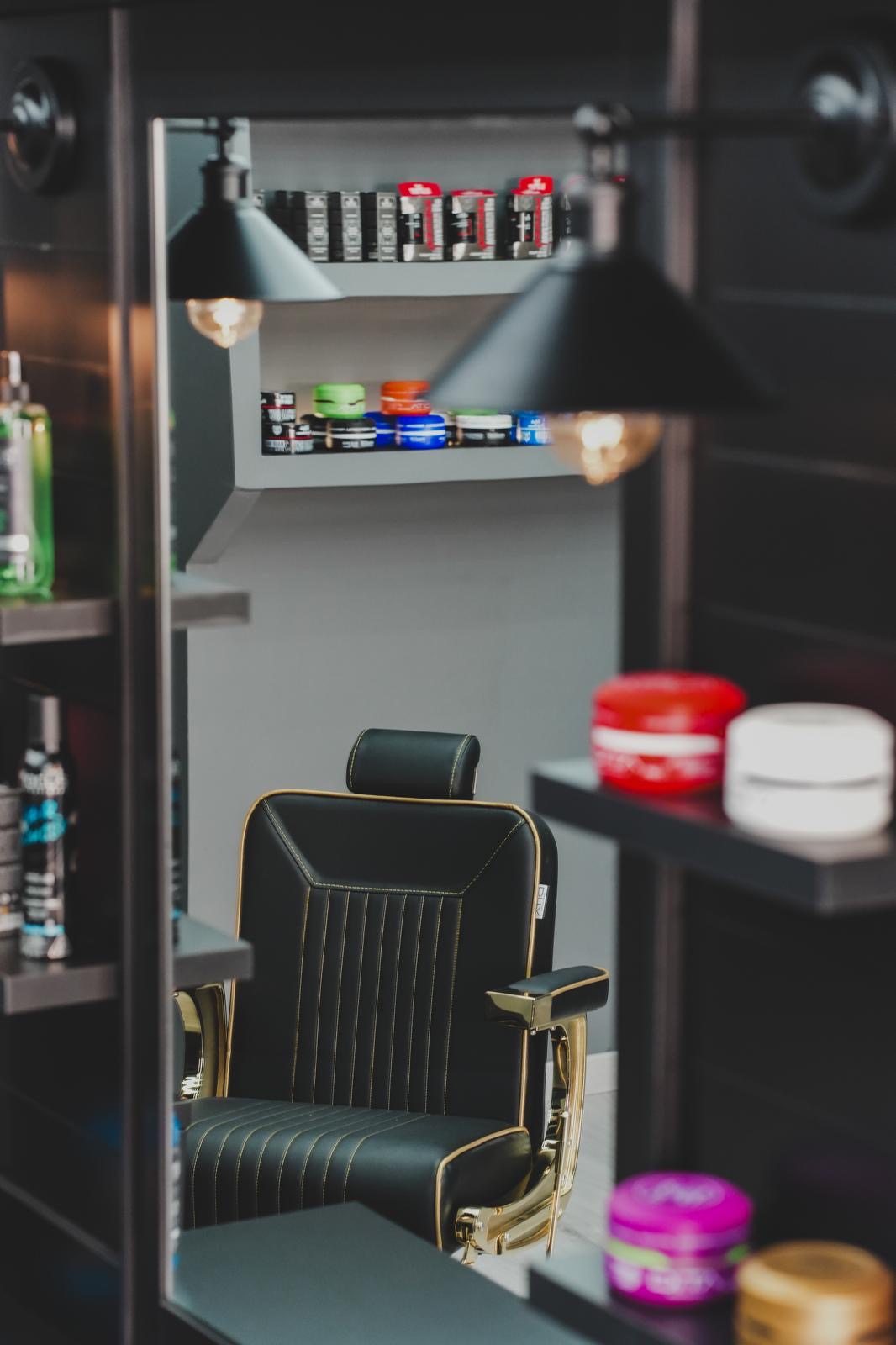 B&G Barber Shop — poltrona da barbiere con dettaglio dorato